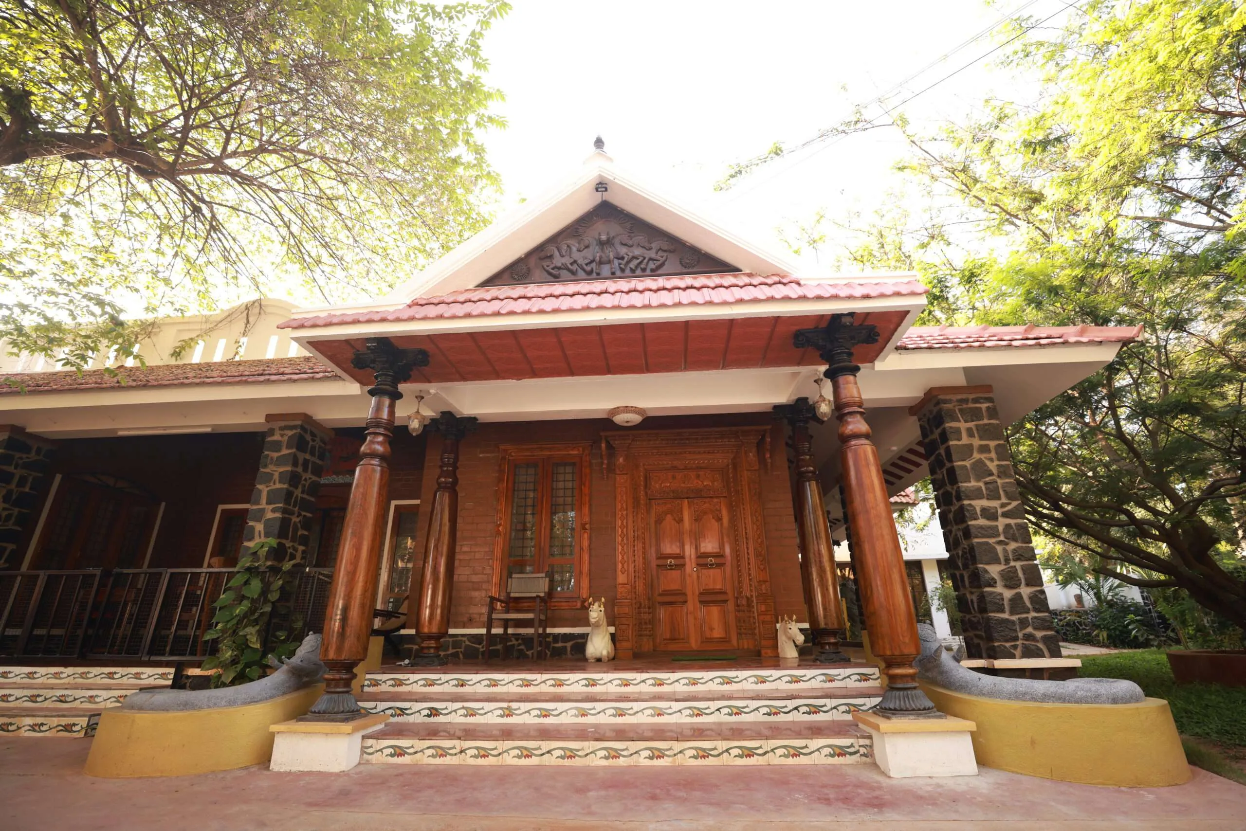 Front Porch with Wooden Pillars & Stone Elephants
